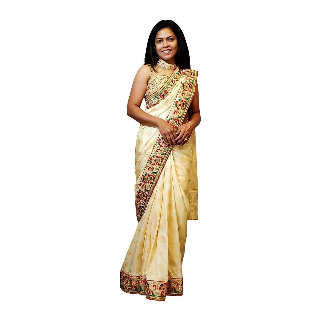 Cream colored brocade soft saree with embroidered border