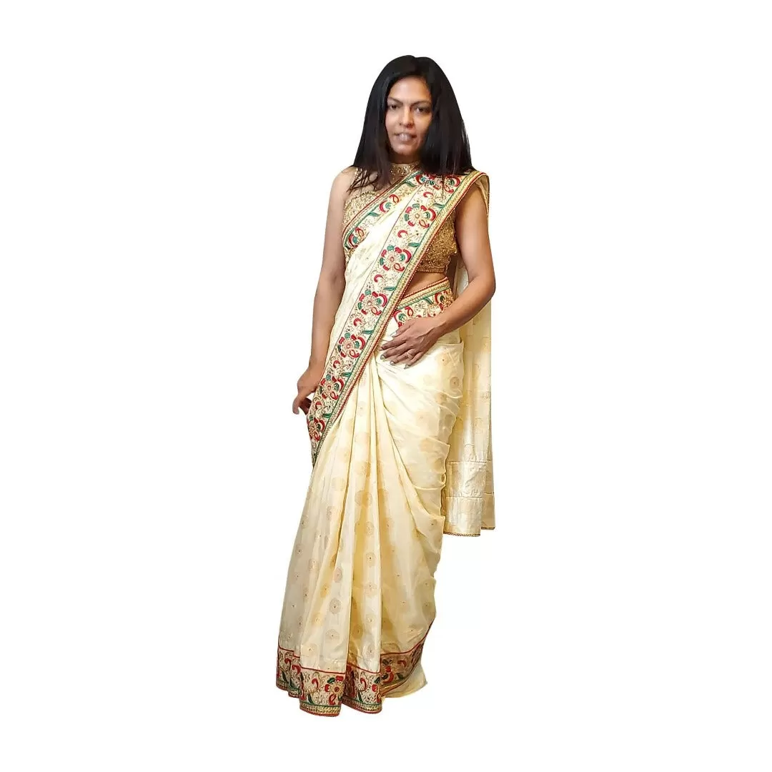 Cream colored brocade soft saree with embroidered border