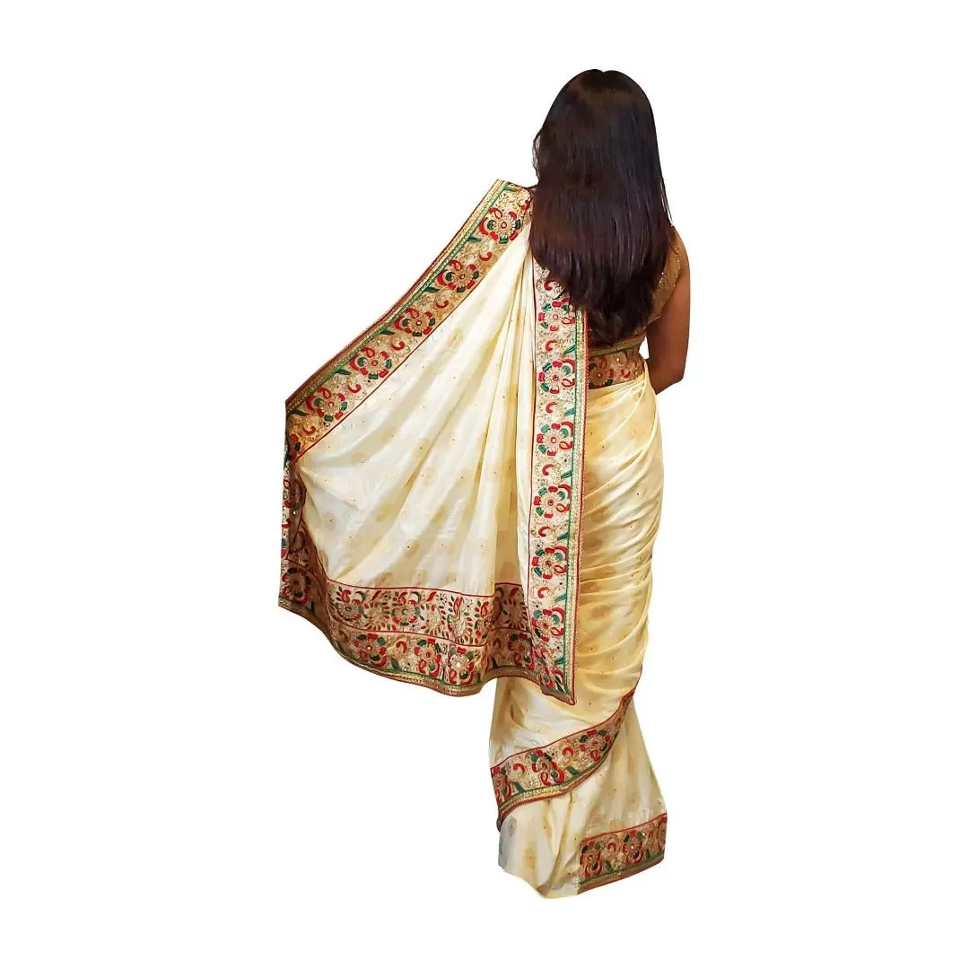 Cream colored brocade soft saree with embroidered border